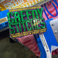 Embroidery machine with a 'Greedy Stitches' label on a blurred background