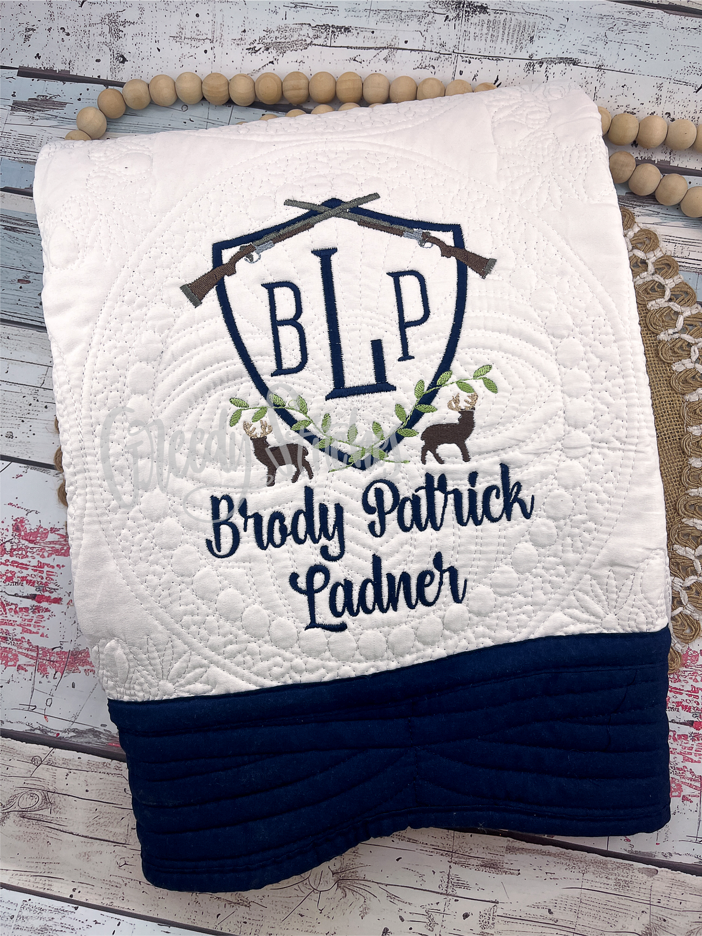 Deer Crest Embroidered Personalized Heirloom Quilt in White with Navy Blue Trim